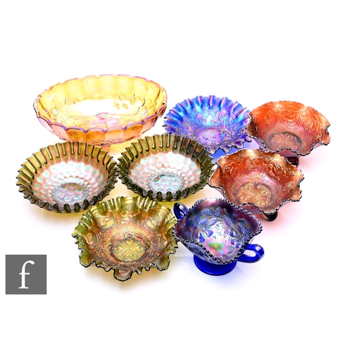 251 - A collection of carnival glass, to include two Fenton footed bowls in the Dragon and Lotus pattern, ... 