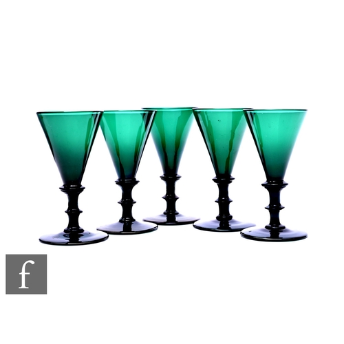 457 - A set of five green wine glasses with a conical bowl above bladed knop, stem with medial bladed knop... 