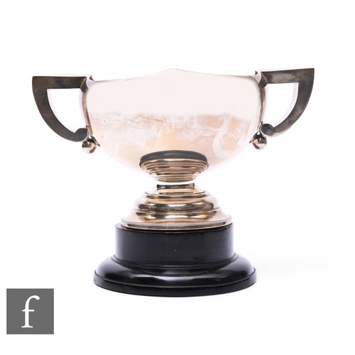 473 - A hallmarked silver twin handled trophy, weight 27oz, height 18cm, London 1929, to a stepped wooden ... 