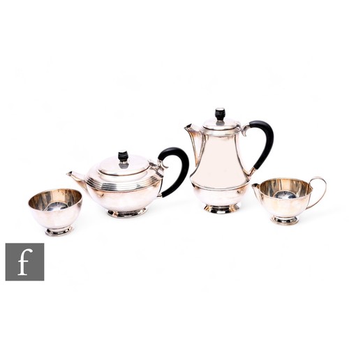 475 - An Art Deco hallmarked silver three piece tea set of squat plain form with reedbed borders, with a m... 