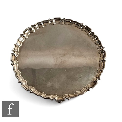 476 - A hallmarked silver circular salver of plain form raised on four lion paw feet, weight 20.5oz, diame... 