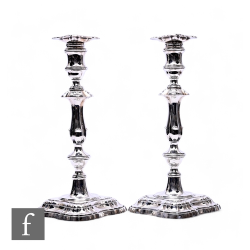 504 - A pair of hallmarked silver candlesticks, stepped square bases below knopped columns and conforming ... 