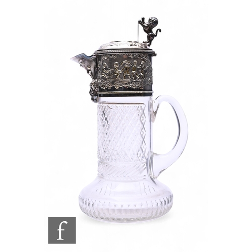 532 - A late 19th Century silver plated and clear cut glass claret jug with decorated with embossed dancin... 