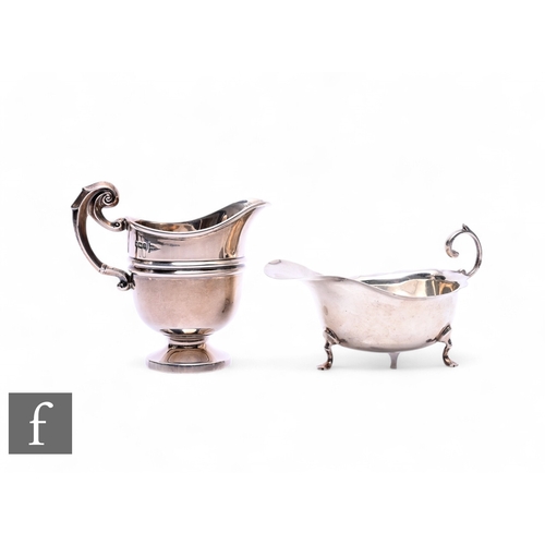 510 - An early 20th Century silver mint sauce boat with scroll handle and raised to three feet, width 12cm... 