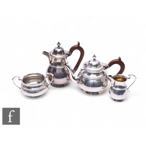 515 - An early 20th Century four-piece tea service in the Georgian style, each piece with a ribbed body an... 