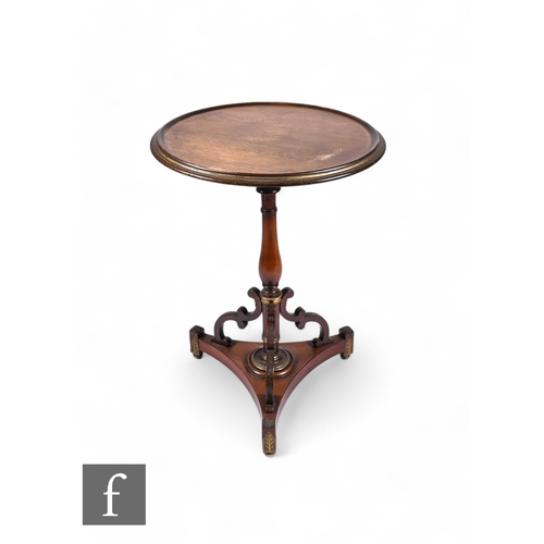 817 - A 19th Century circular parcel gilt mahogany occasional table, the raised circular edge top on a sle... 