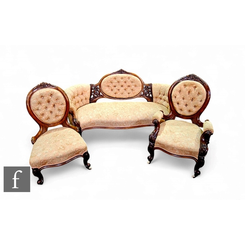 819 - A Victorian carved walnut three seater settee, pierced framed and buttoned panel back with matching ... 