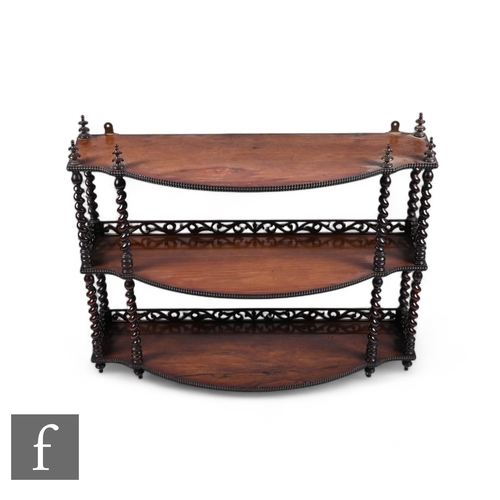 821 - A 19th Century three tier bowfront set of wall shelves, turned spiral uprights and pierced gallery b... 