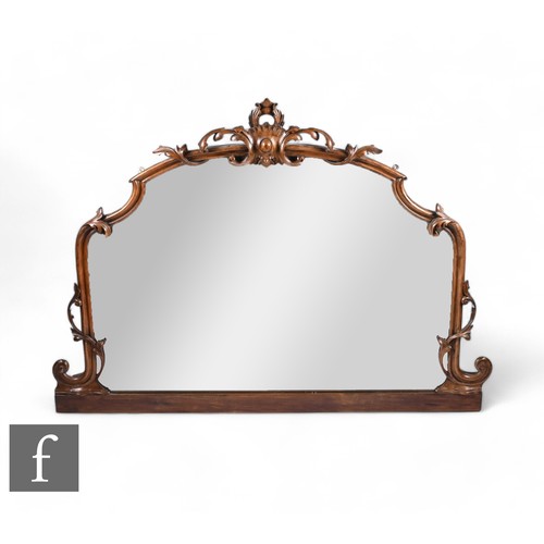 820 - A Victorian carved walnut overmantle mirror, scroll and leaf design, height 106cm x width 130cm.