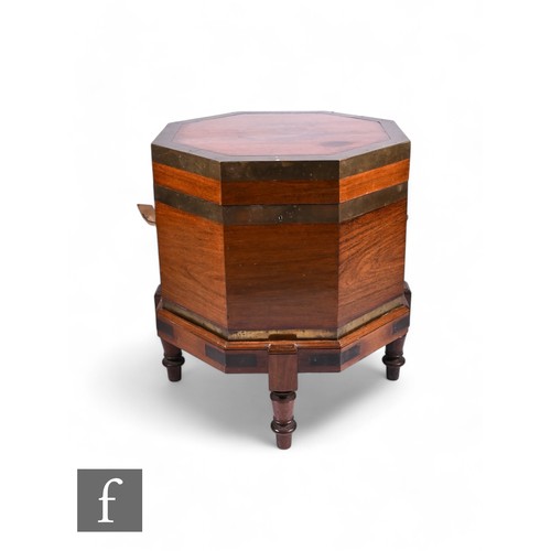 831 - A 19th Century colonial brass bound padauk wood octagonal cellarette, with twin handles and raised t... 