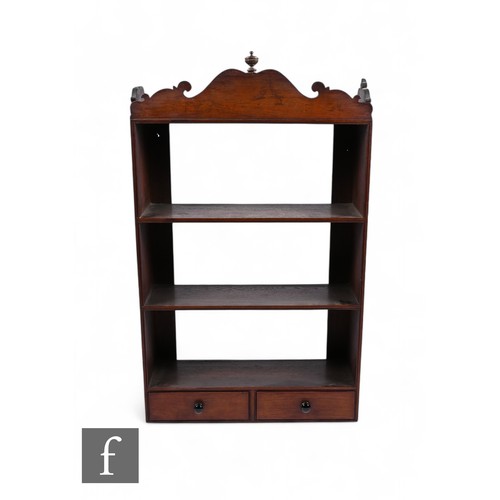 834 - A 19th Century padauk wood bracket shelf, with fret-cut pediment over three shelves and two small dr... 