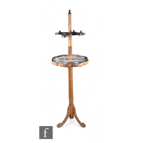 837 - A rustic ecclesiastical five-light candlestick, with toleware drip tray below and raised to an octag... 