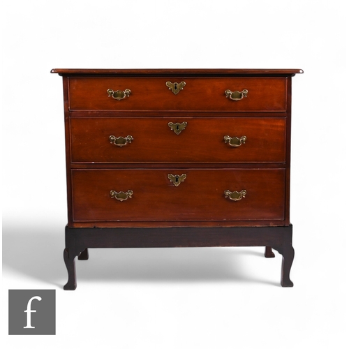 842 - A George II red walnut graduated chest of three long drawers on stand, with thumb-moulded edge to th... 