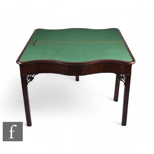 844 - A George III mahogany serpentine fronted fold-over card table of over-sized proportions, the green b... 