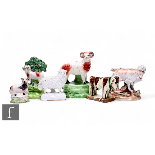 69 - A collection of Staffordshire animal figures, including a standing ram, with brown sponged decoratio... 