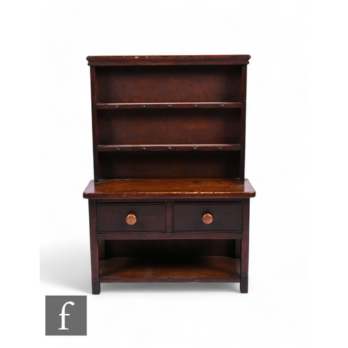 851 - A 19th century apprentice stained pine dresser and rack, fitted two drawers on block legs united by ... 