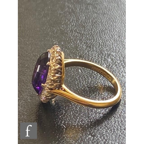 1 - An 18ct amethyst and diamond cluster ring, central oval amethyst within a border of sixteen individu... 