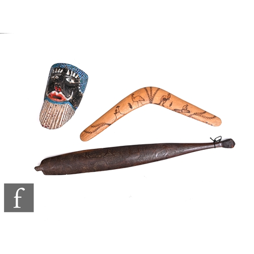 582 - An Aboriginal carved hardwood spear thrower, decorated with an emu and a kangaroo, length 71cm, toge... 