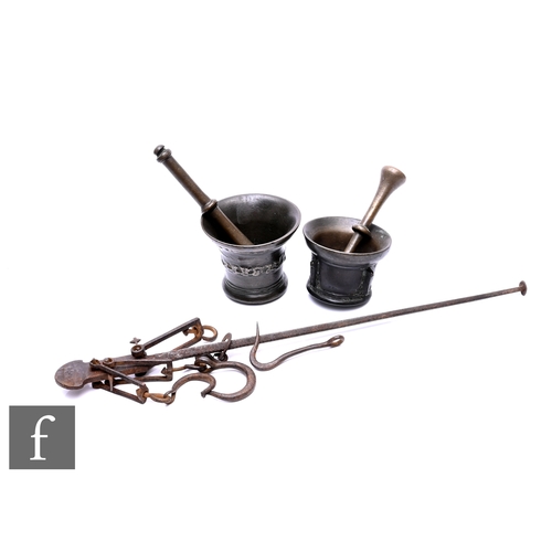 589 - Two 17th century bronze pestles and mortars and an early 18th century steel yard dated 1709. (3)