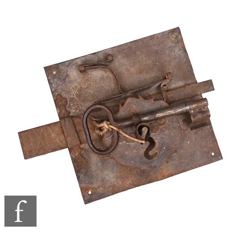 590 - A large 17th or 18th century church door lock and key on square metal plate, 35cm x 35cm.