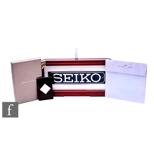 601 - A Bulgari notebook, boxed, a Patek Philippe watch cleaner and a poster folder, also a replica 'Seiko... 