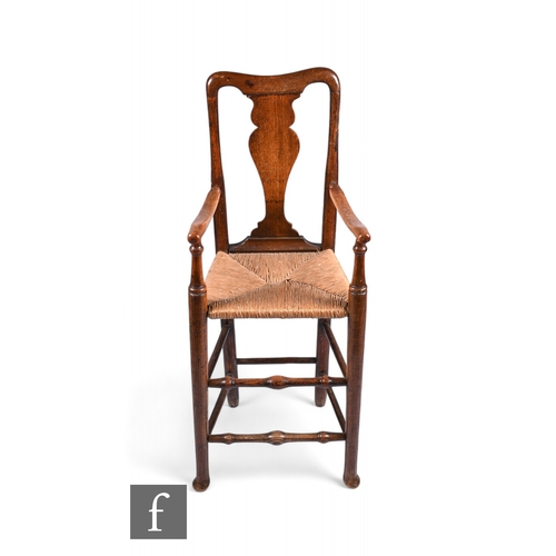 860 - An 18th Century child's ash framed high chair, with vase shaped splat above the woven grass seat and... 