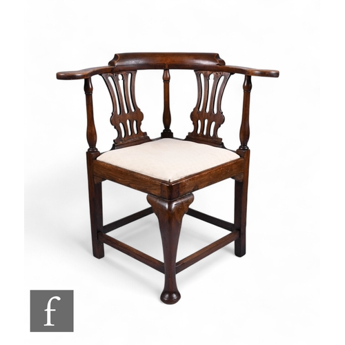 865 - A late 18th Century ash framed corner armchair, with twin pierced lyre shaped back over a cabriole f... 