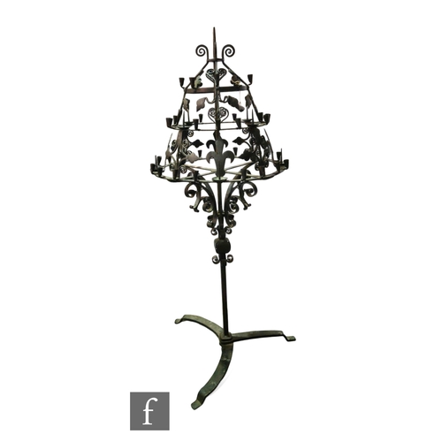 866 - An early 20th Century wrought iron three-tier floor standing candelabra, with thirty six sconces and... 