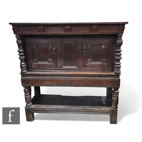 868 - A late 17th Century oak hutch cupboard on stand, with dentil cornice above turned pilaster supports ... 