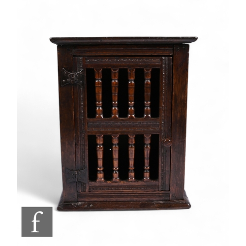 872 - A 17th Century oak dole cupboard, with chip carved detail and turned spindle door, height 58cm, widt... 