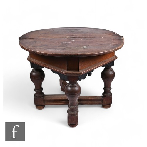 873 - An 18th Century Dutch oak credence table of demi lune form, the hinged top over bulbous baluster tur... 