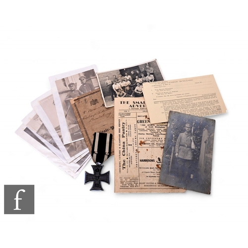 638 - A World War One German Iron Cross with identification card/pass and a small collection of photograph... 