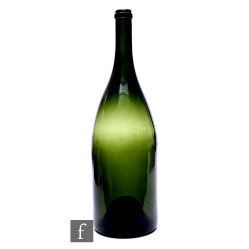 439 - A green glass jeroboam wine bottle, with kick-up base, height 46.5cm.