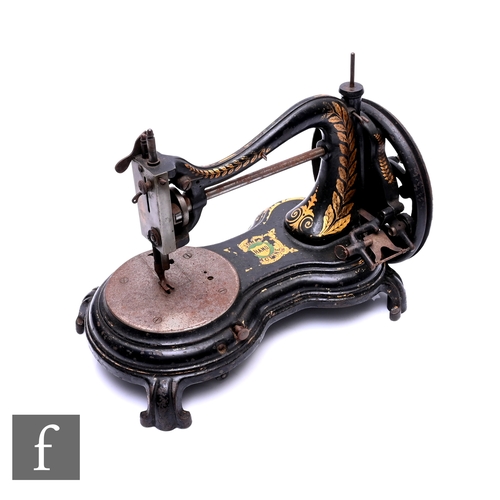 507 - A late 19th Century Jones cast iron sewing machine, hand crank operation, on scroll feet, width 34cm... 