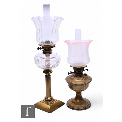 508 - A Victorian style brass oil lamp and shade, a similar lamp and chimneys. (2)