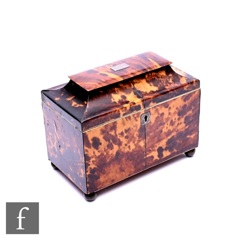 512 - A 19th Century tortoiseshell tea caddy, the caddy shaped top over a two divisioned interior, on bras... 