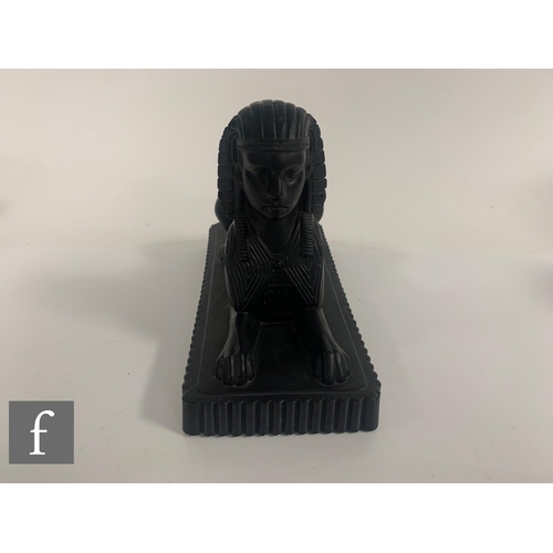 277 - A Molineaux, Webb & Co pressed matt black glass figure of an Egyptian Sphinx circa 1875, the rec... 