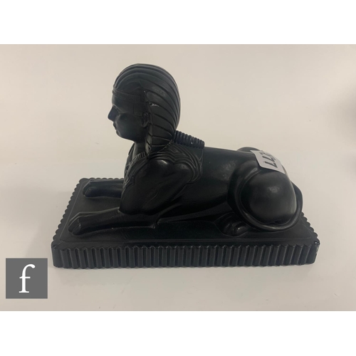 277 - A Molineaux, Webb & Co pressed matt black glass figure of an Egyptian Sphinx circa 1875, the rec... 