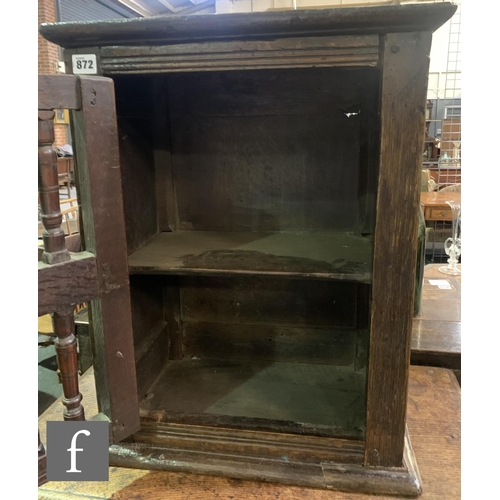 872 - A 17th Century oak dole cupboard, with chip carved detail and turned spindle door, height 58cm, widt... 