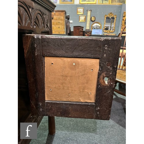 870 - A 17th Century and later oak hutch cupboard, with lunette frieze and conforming rosette carved panel... 