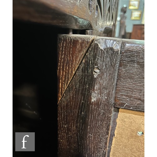 870 - A 17th Century and later oak hutch cupboard, with lunette frieze and conforming rosette carved panel... 