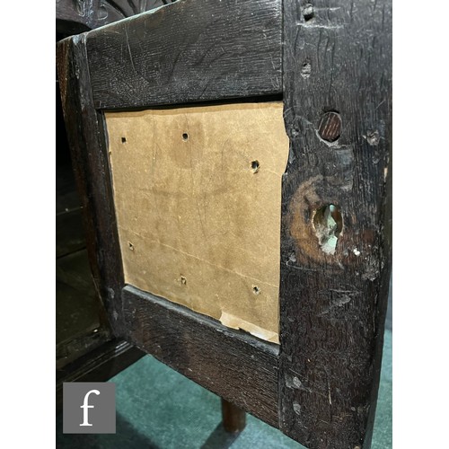 870 - A 17th Century and later oak hutch cupboard, with lunette frieze and conforming rosette carved panel... 