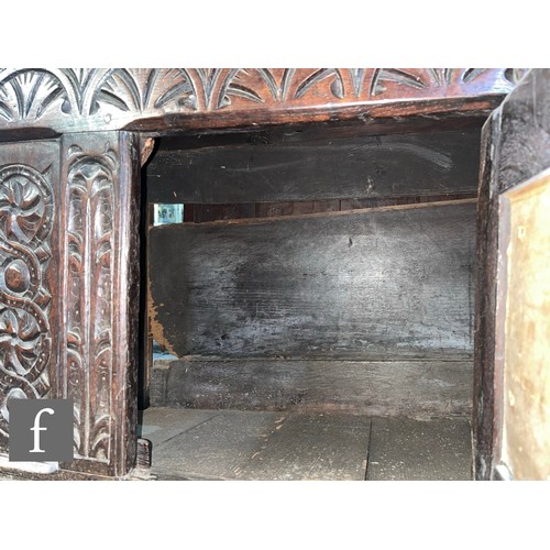 870 - A 17th Century and later oak hutch cupboard, with lunette frieze and conforming rosette carved panel... 