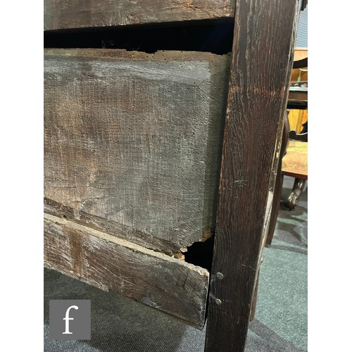 870 - A 17th Century and later oak hutch cupboard, with lunette frieze and conforming rosette carved panel... 