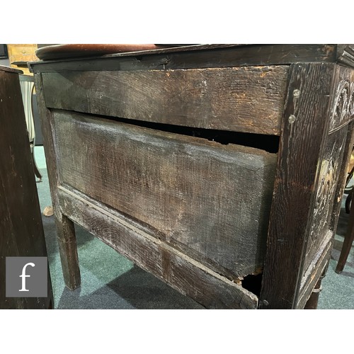 870 - A 17th Century and later oak hutch cupboard, with lunette frieze and conforming rosette carved panel... 