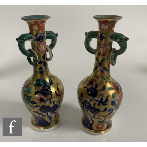 89 - A pair of Miles Mason vases, of inverse baluster form with high drawn neck, twin mask loop and ring ... 