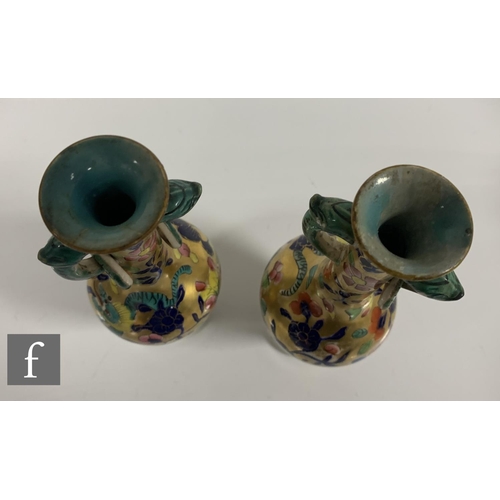 89 - A pair of Miles Mason vases, of inverse baluster form with high drawn neck, twin mask loop and ring ... 