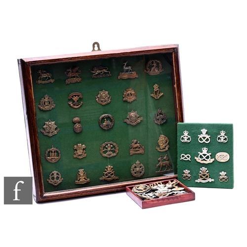 647 - A collection of military badges to include various regiments, a small board of badges and loose badg... 