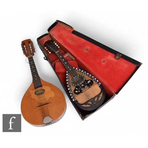 527 - An early 20th Century Italian inlaid mandolin, cased, another cased and a Romanian example. (3)