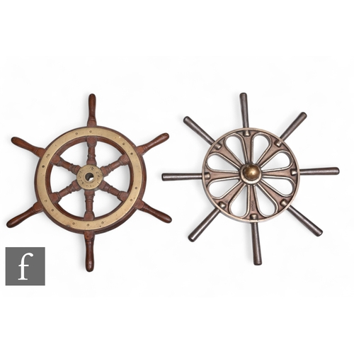 540 - A replica mahogany and brass small ships wheel and a heavy replica cast brass ships wheel. (2)